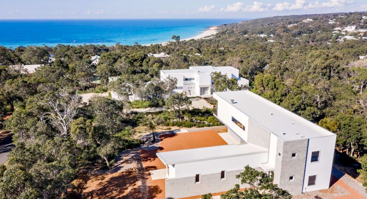 A flight of stairs leading to the sandy beach and bright blue waters of Eagle bay beach in Western Australia