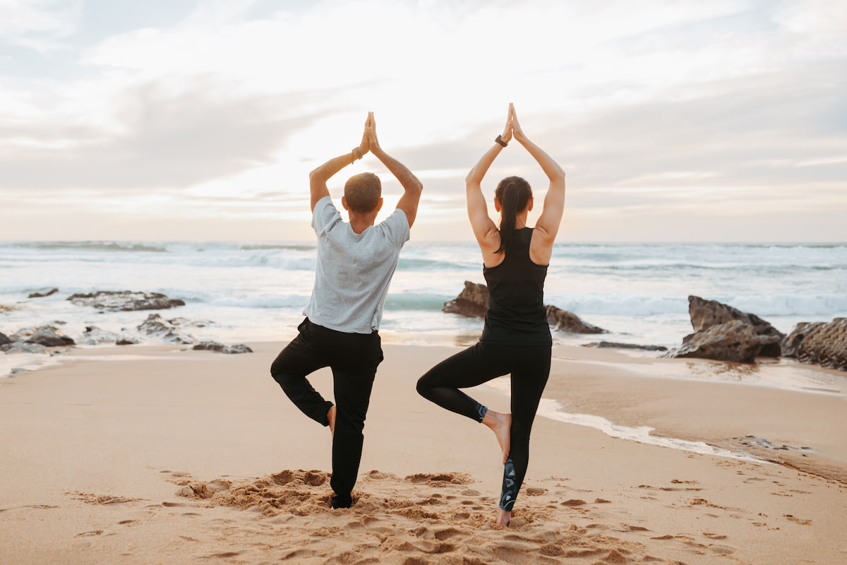 guests doing yoga at the beach