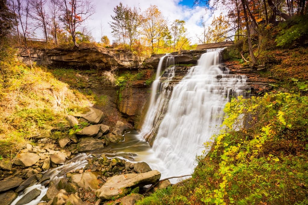 Waterfall surrounded by fall coloured foliage at Brandywine Falls in Whistler