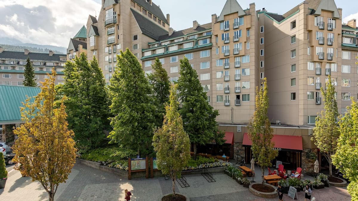 View down of the Fairmont hotel and restaurants from the apartment with tall green trees on the ground