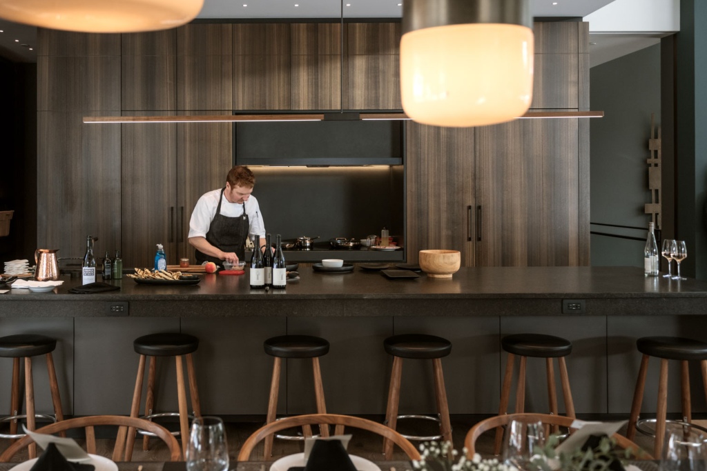 Private chef preparing a gourmet dinner in a Whistler vacation chalet using fresh, locally sourced ingredients.