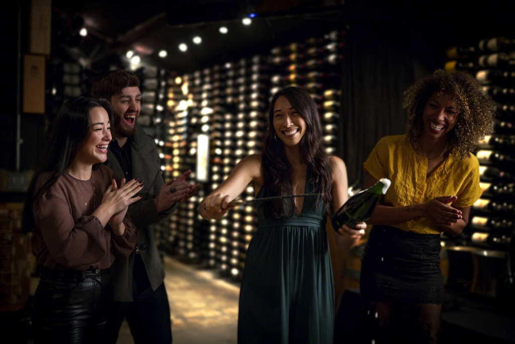 Guests at Whistler's Bearfoot Bistro in the wine cellar enjoying champagne sabering